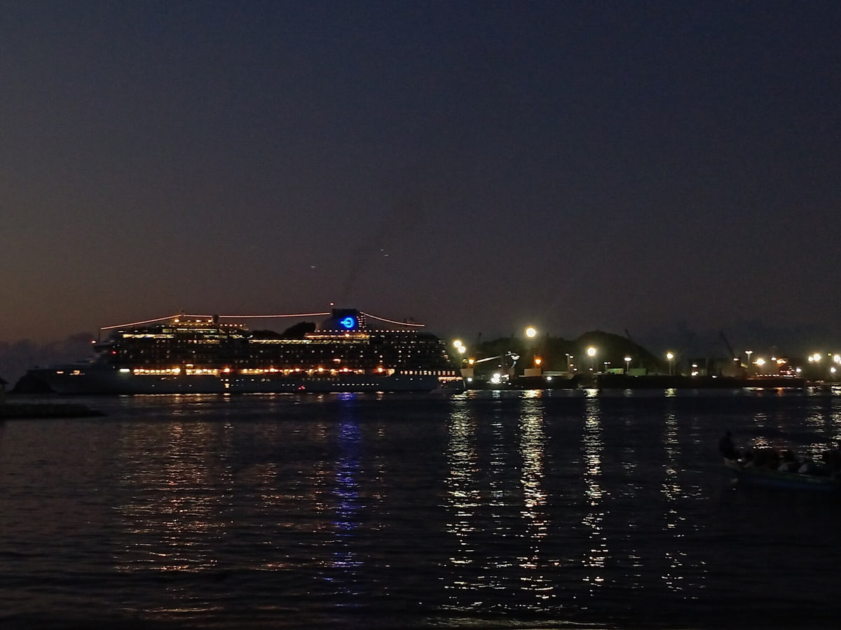 Oceania's Vista cruise ship at night seen leaving from the cargo port of Colombian city Santa Marta